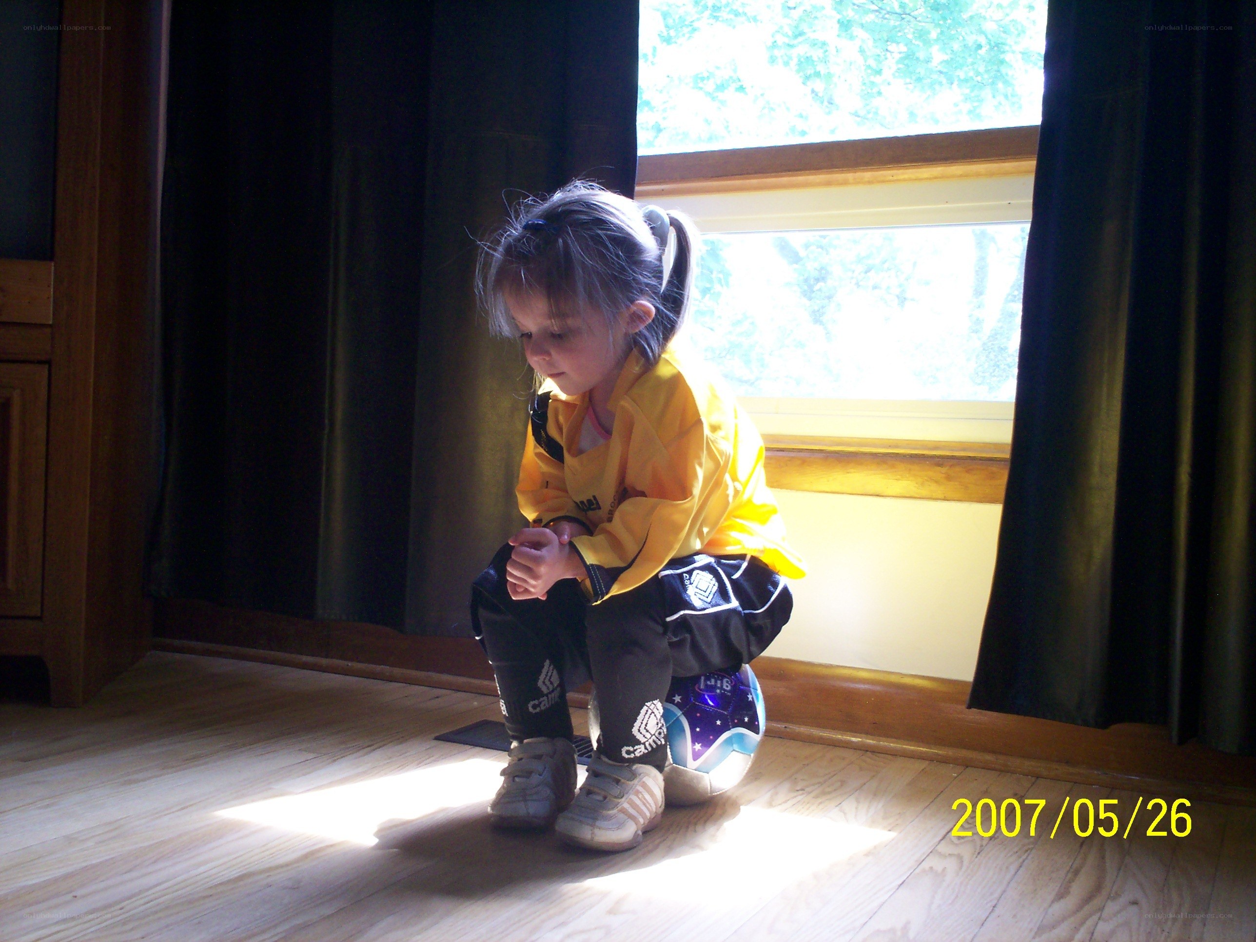 child sitting by window