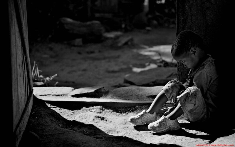 Child sitting in shadow