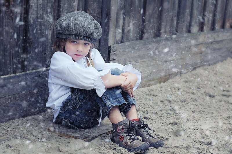 Child Sitting in Snow