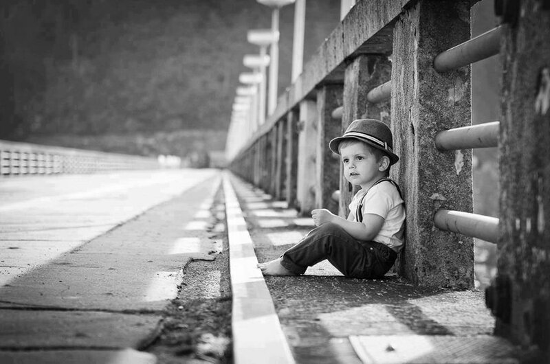 Child Sitting on Bridge
