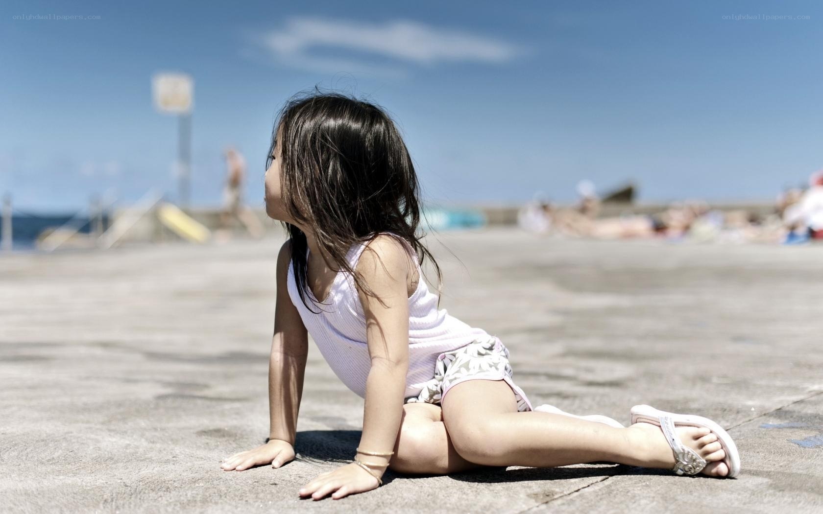 child sitting on concrete