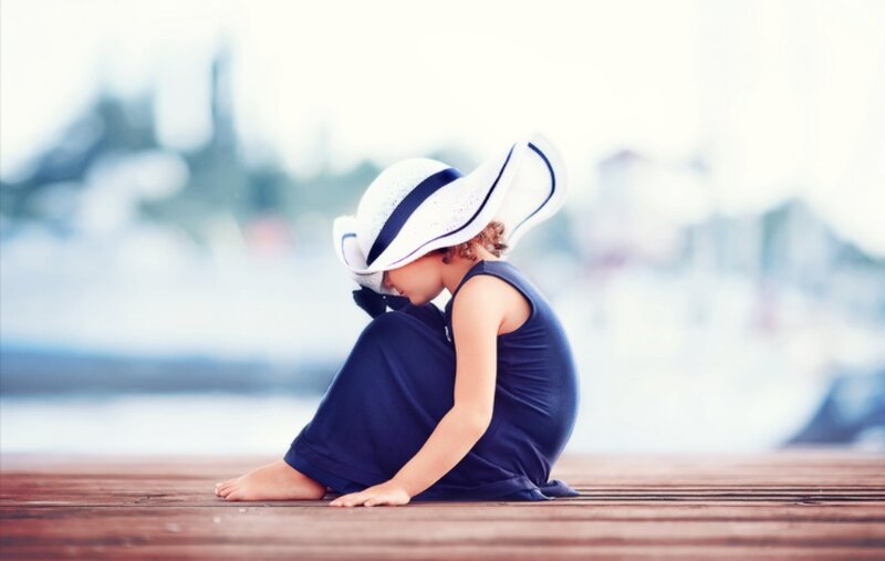 Child Sitting on Dock — Blue