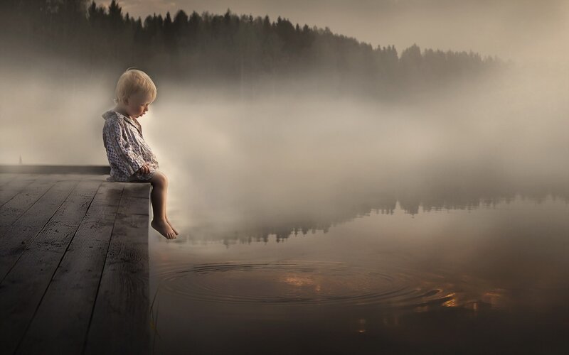 Child Sitting on Dock — Brown