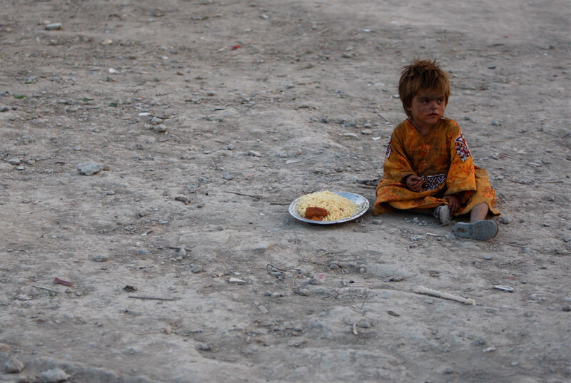 Child sitting on dusty ground