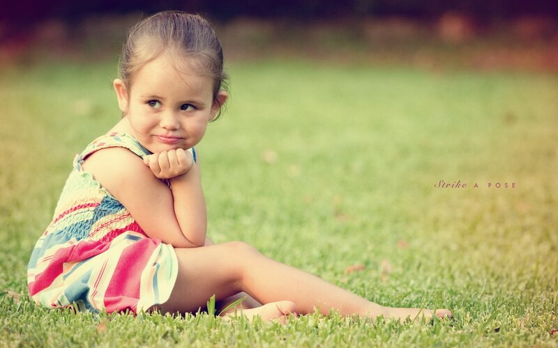 child sitting on grass