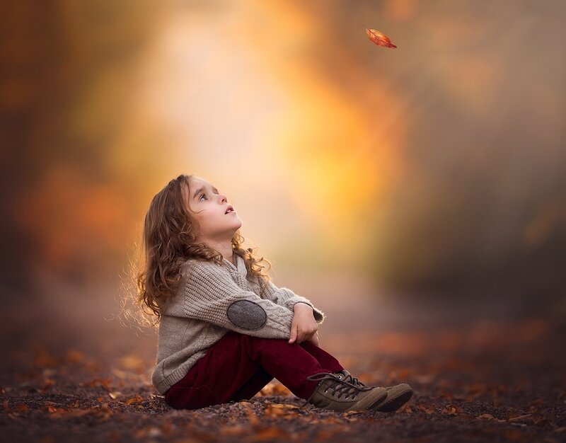 Child Sitting on Ground — Brown, Serene, Autumn