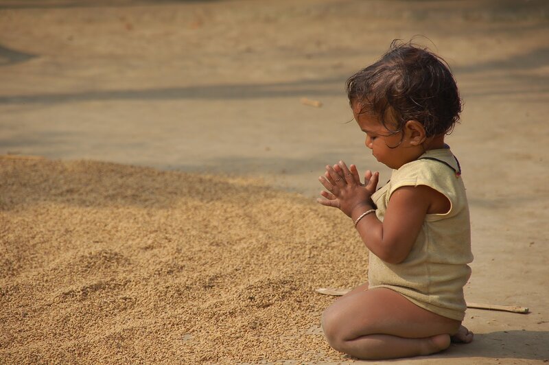 Child Sitting on Ground — Brown