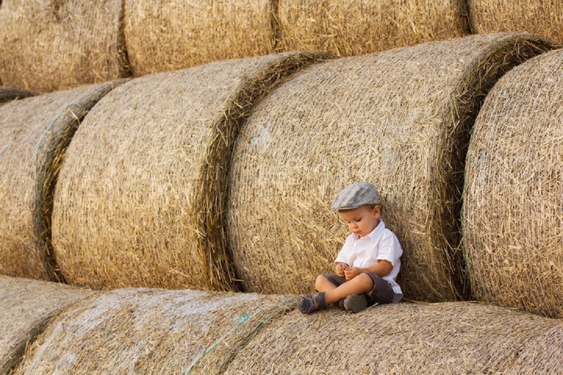 Child Sitting on Hay Bales