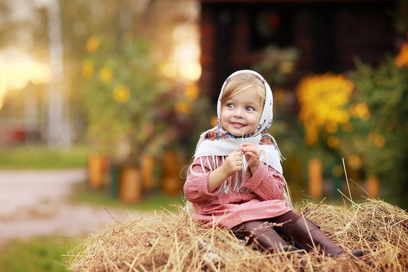 Child Sitting on Hay