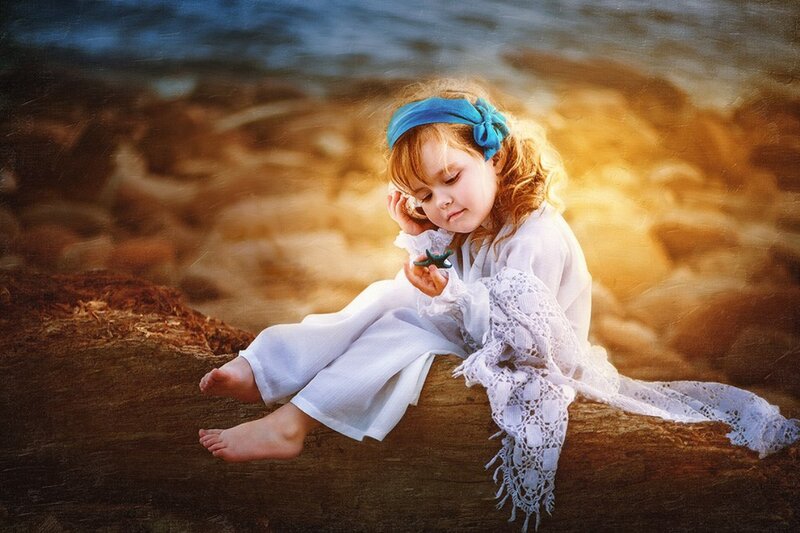 Child Sitting on Log
