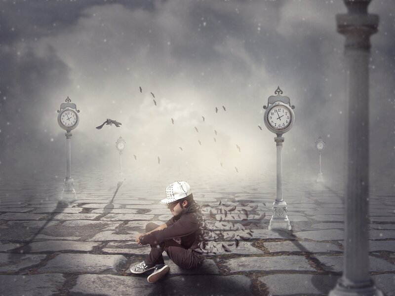 Child Sitting on Pavement — Gray