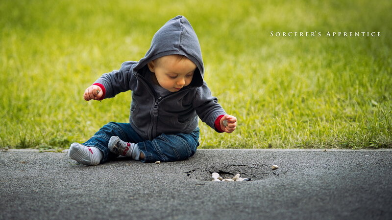 Child Sitting on Pavement