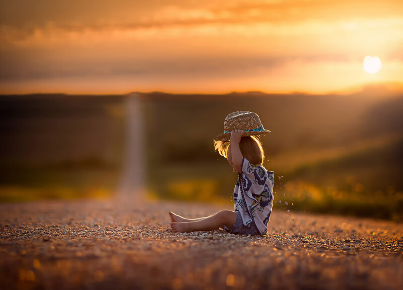 Child Sitting on Road — Orange