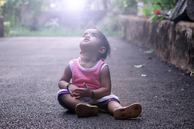 Child Sitting on Road — Pink