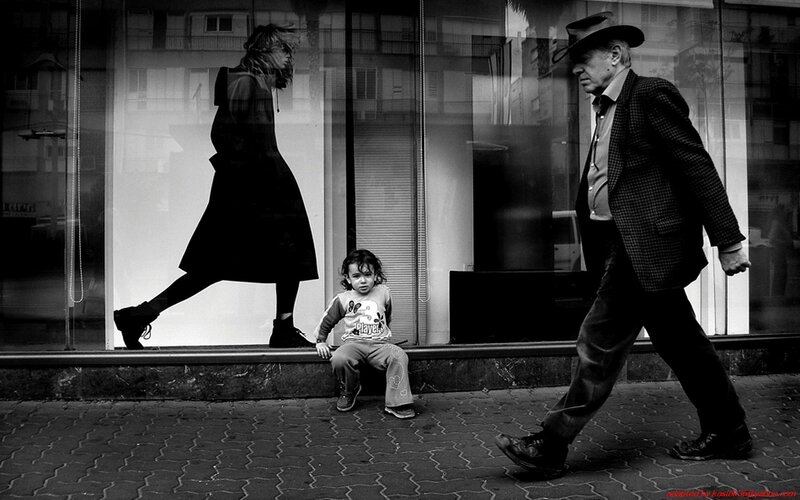 Child sitting on sidewalk
