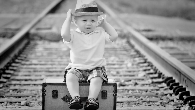 Child Sitting on Suitcase — Black