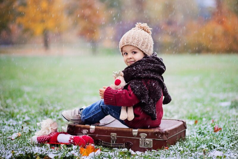 Child Sitting on Suitcase — Green
