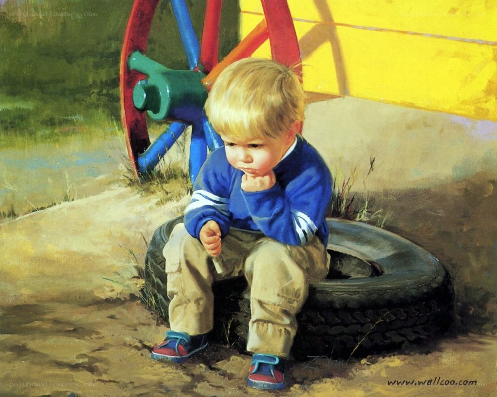 child sitting on tire