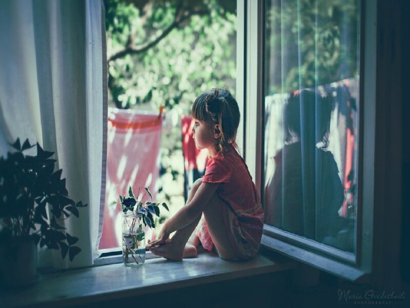 Child Sitting on Windowsill — Green
