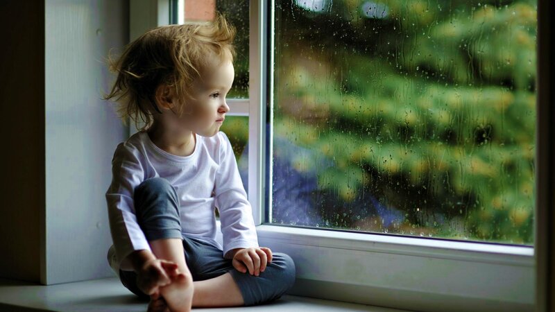 Child Sitting on Windowsill — White, Contemplative
