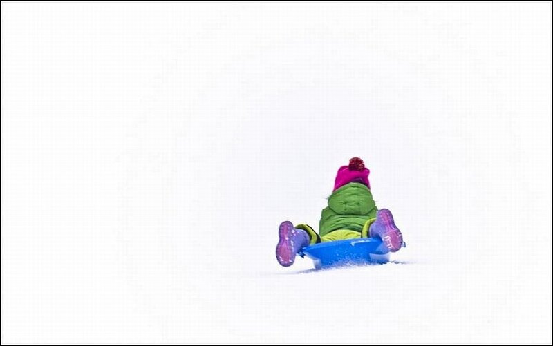 Child Sledding in Snow