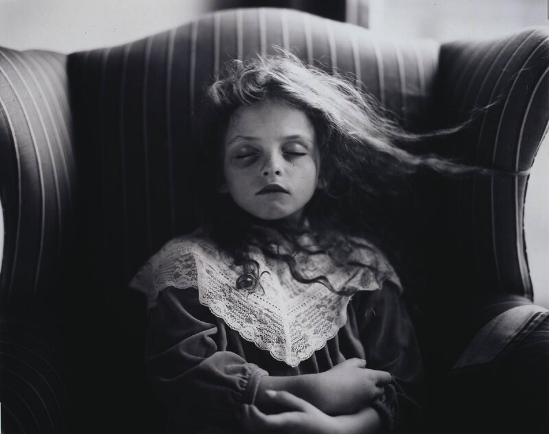 child sleeping in armchair