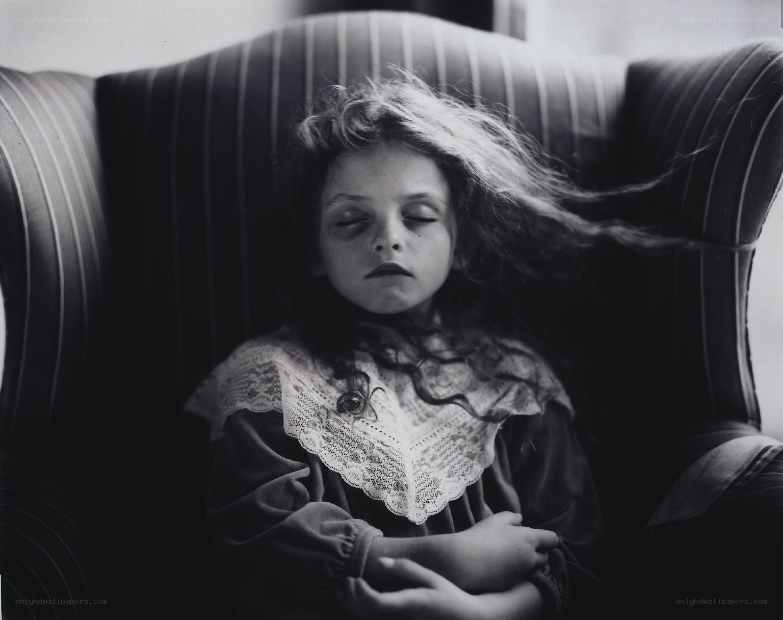 child sleeping in armchair