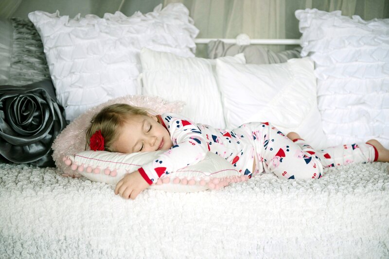 Child Sleeping on Bed — White