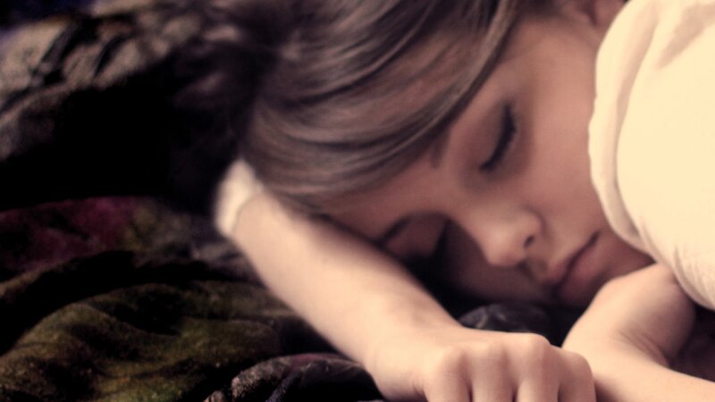 Child Sleeping on Blanket