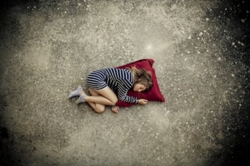 Child Sleeping on Ground