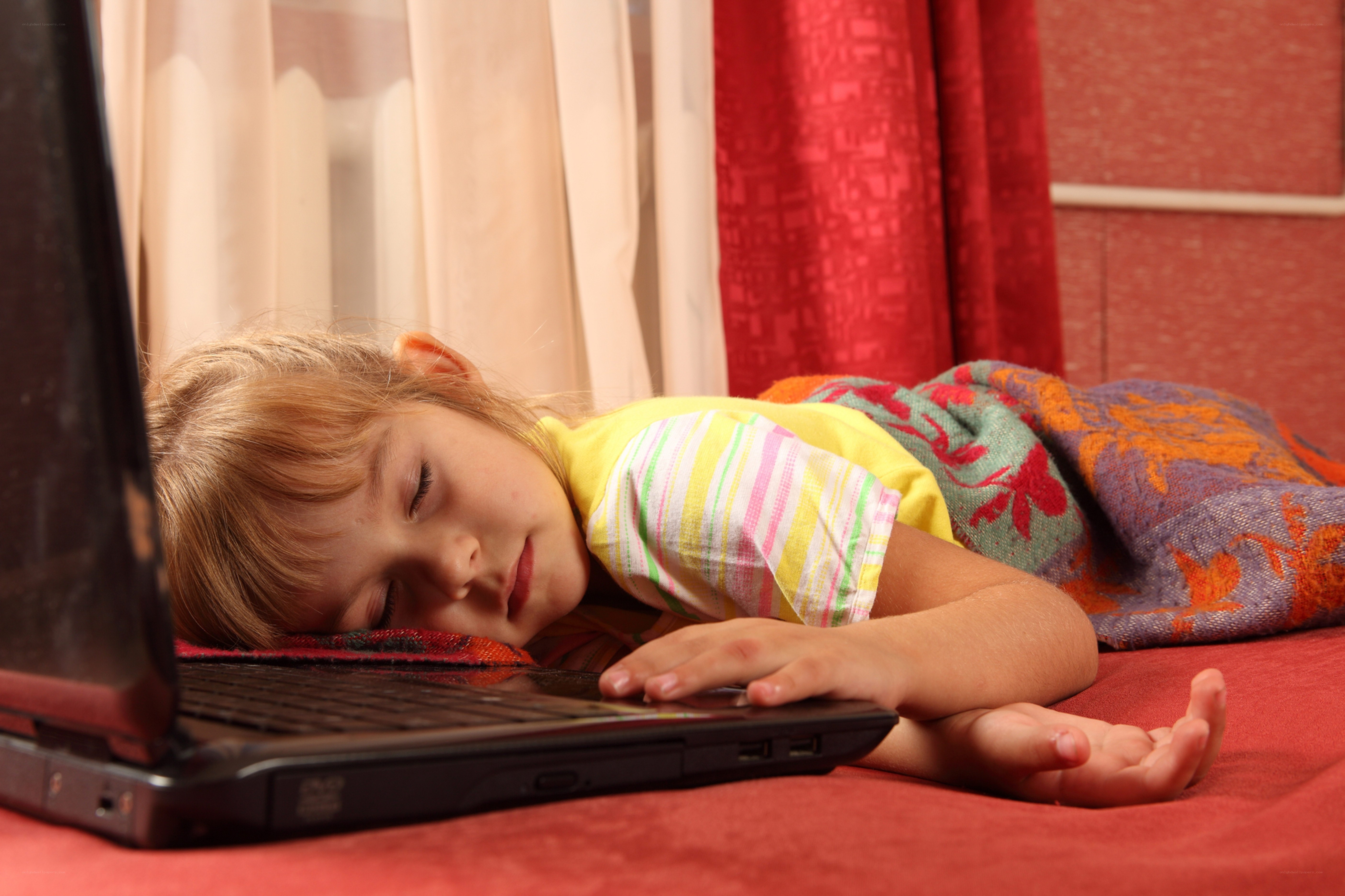 child sleeping on laptop