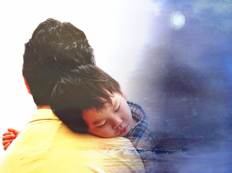 child sleeping on parent's back