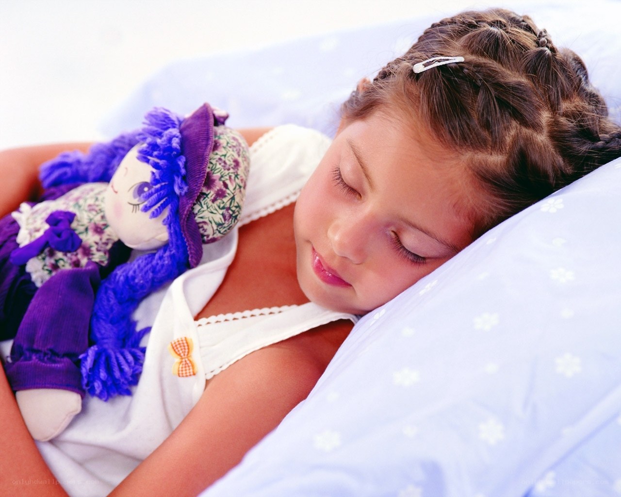 child sleeping with doll