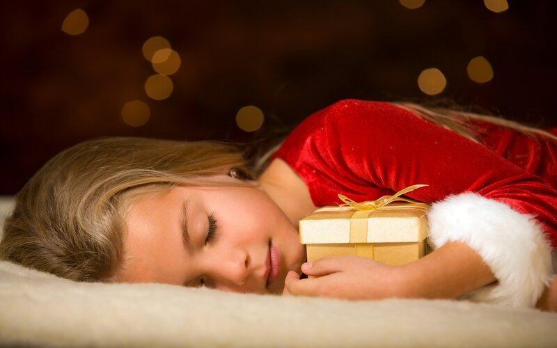child sleeping with gift