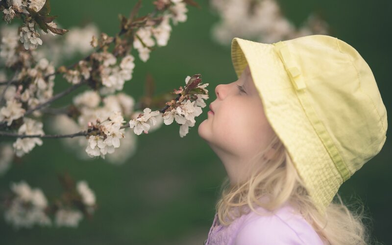 Child Smelling Flowers — Yellow
