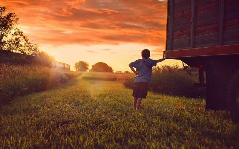 Child Standing by Truck