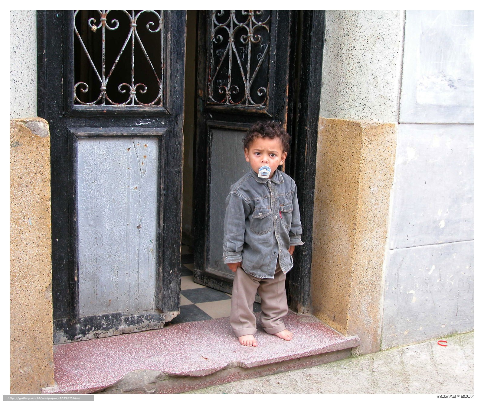 child standing in doorway