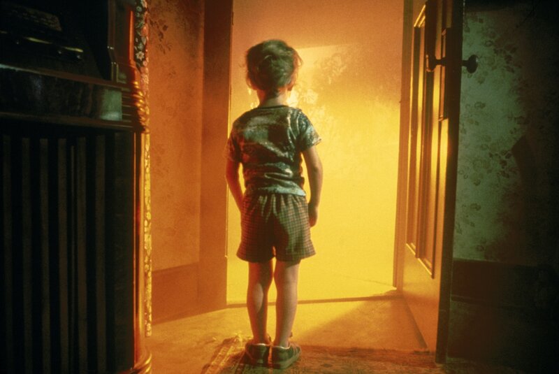 Child Standing in Hallway