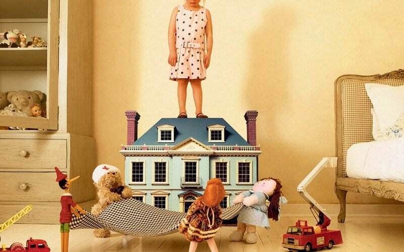 Child Standing on Dollhouse