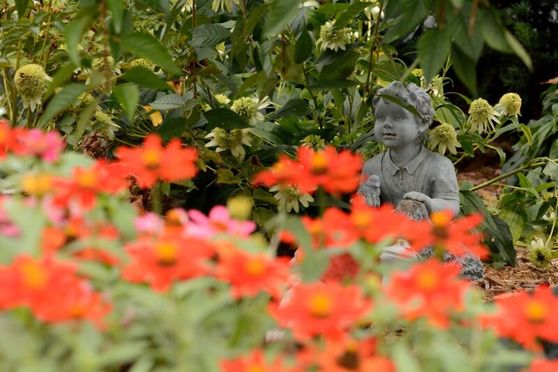 Child Statue in Garden — Red, Serene