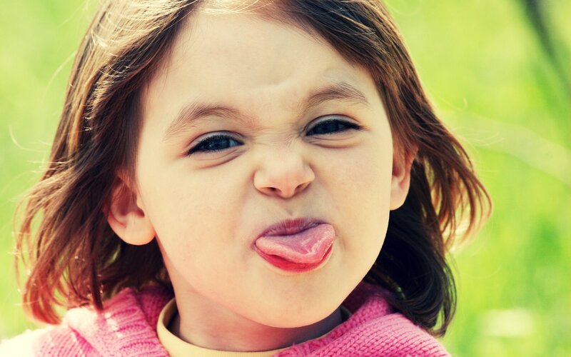 child sticking out tongue