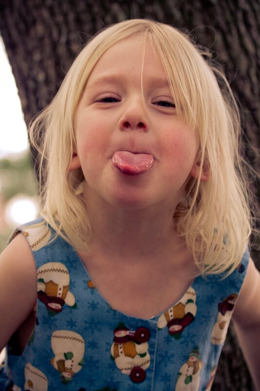child sticking out tongue
