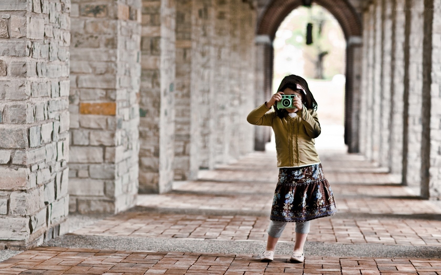 child taking a photo in a corridor