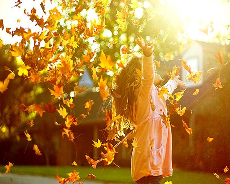 Child Throwing Leaves — Yellow
