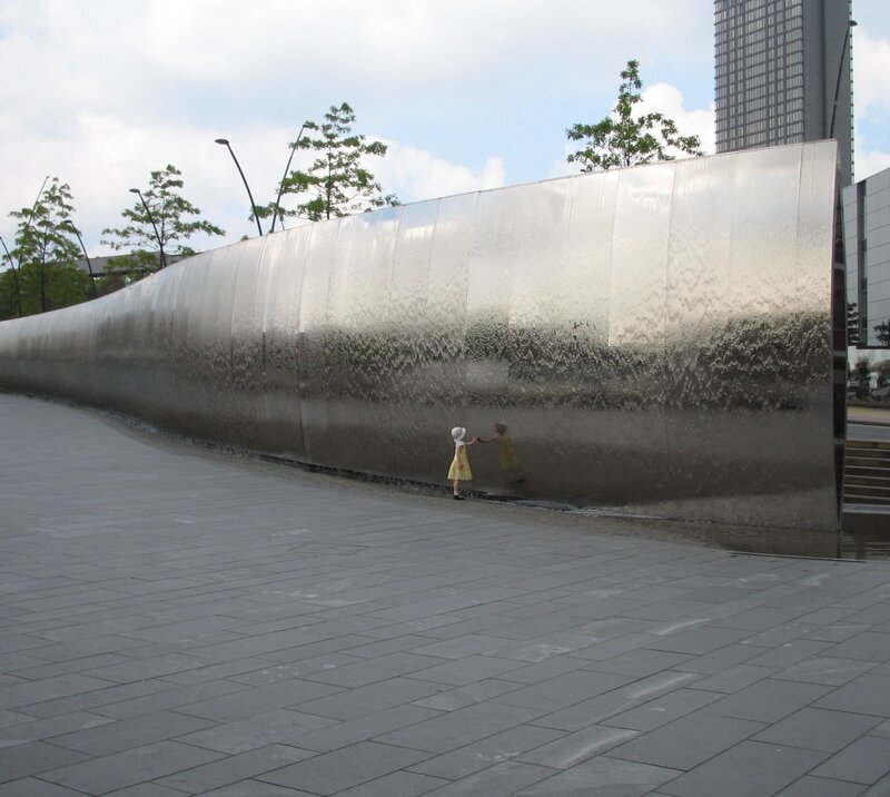 Child Touching Water Wall