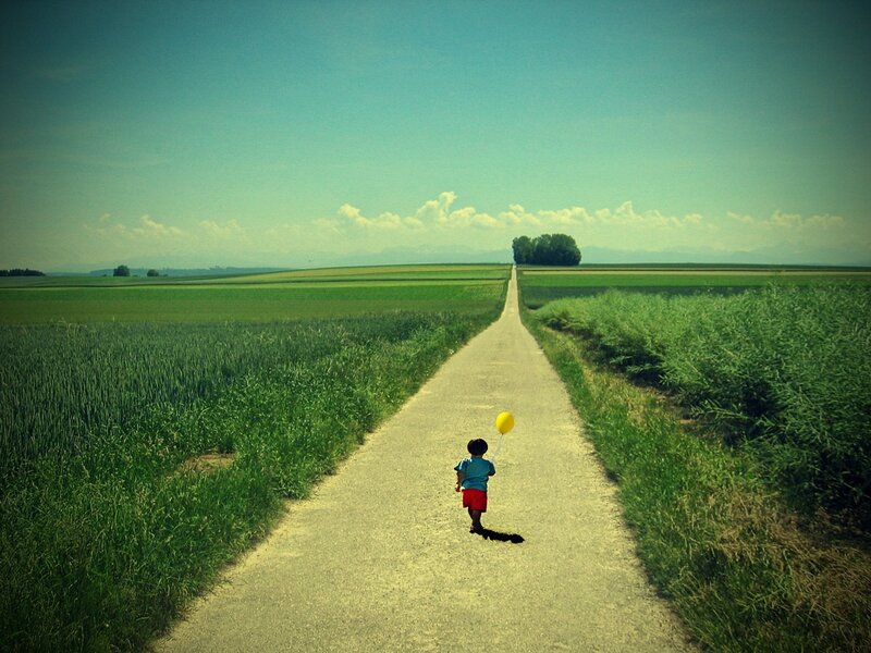 Child walking down a country road