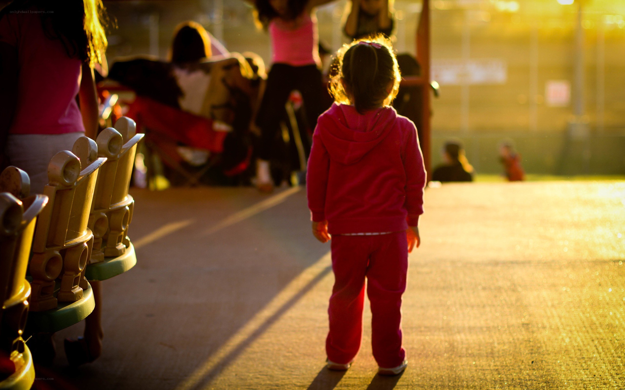 Child walking in playground at sunset