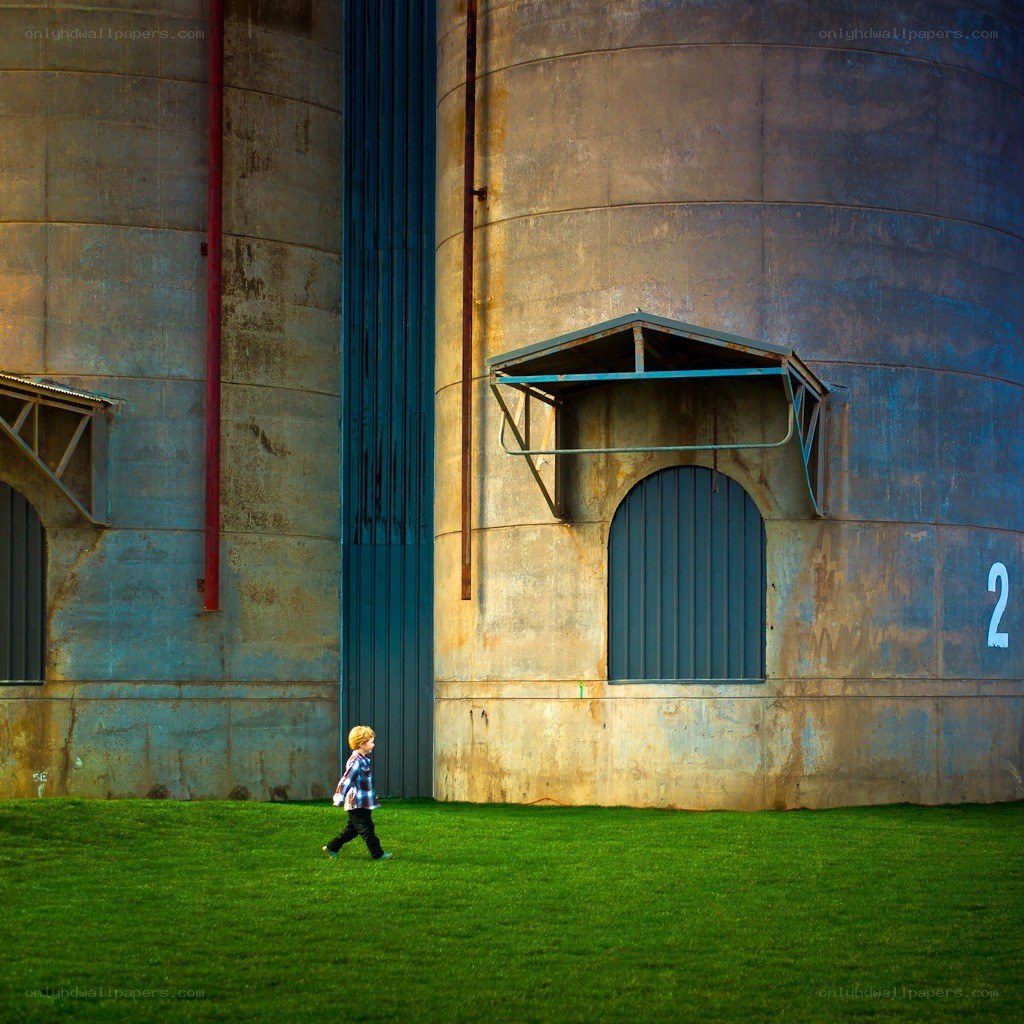 Child walking near silos