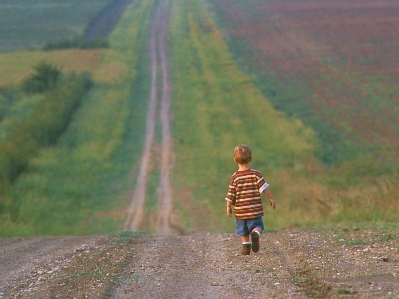 child walking on a dirt road