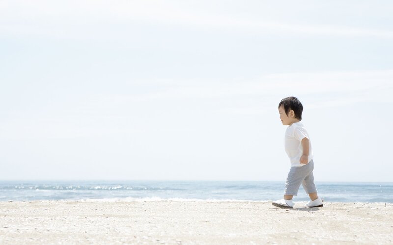 Child Walking on Beach — White